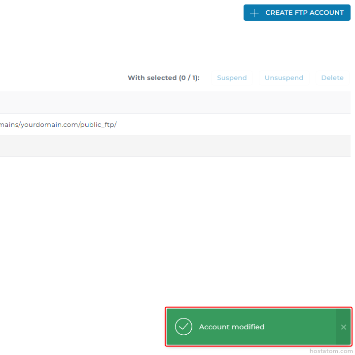 Admin FTP account management panel with a blue Create FTP Account button, an actions bar (Suspend, Unsuspend, Delete) and a green 'Account modified' success toast in the bottom-right.
